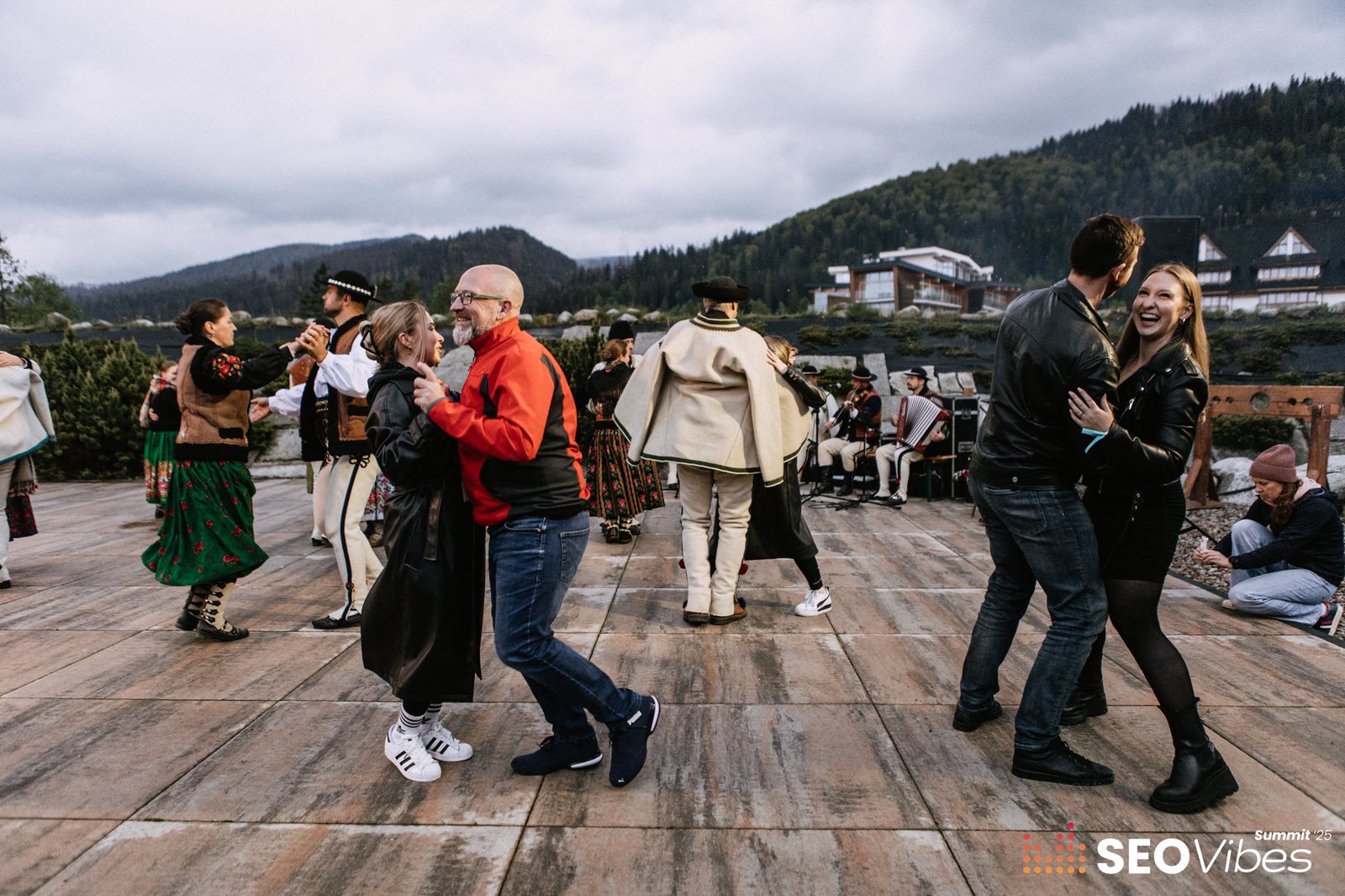SEO Vibes Summit 2025 participants dancing to live folk music during the evening barbecue in Zakopane.