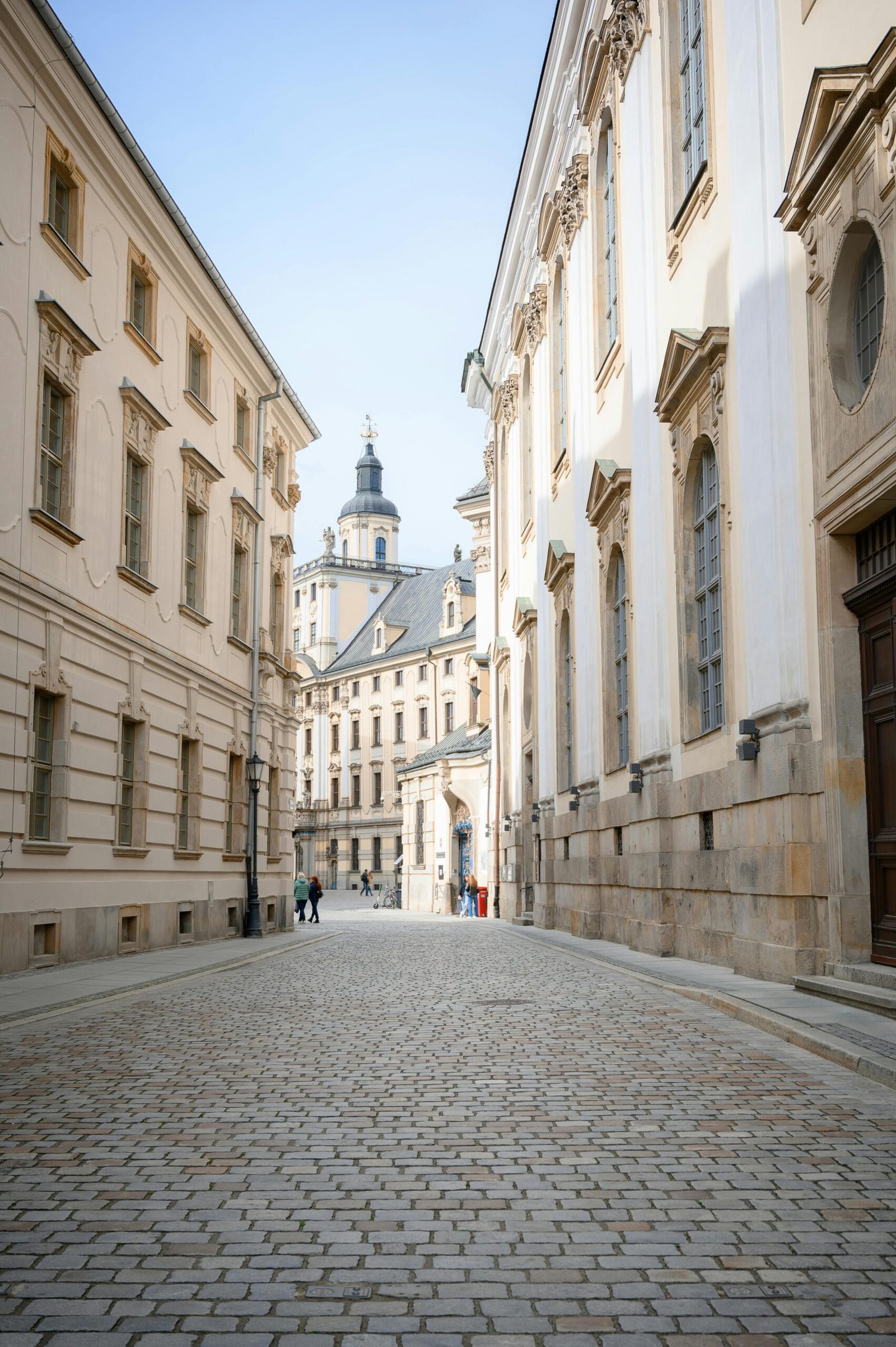 A view of the street leading to the University of Wroclaw's main building, a central part of student life that is easily accessible even for those living on a Wroclaw on a Budget.