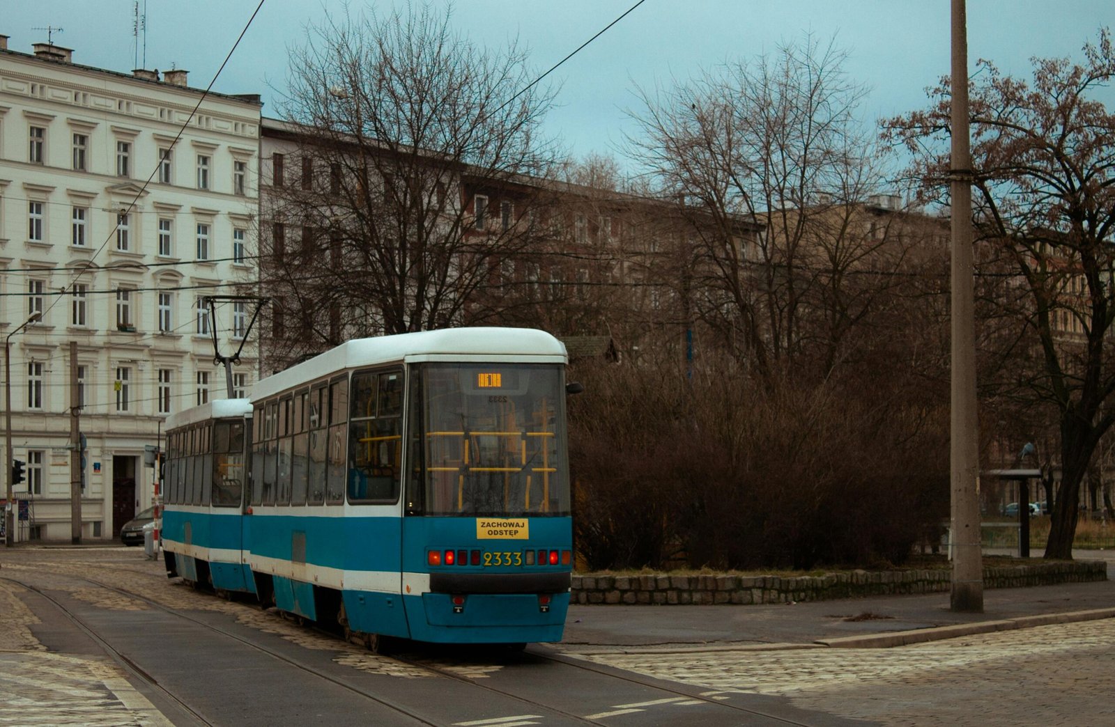 A tram traveling through the streets of Wroclaw, representing an affordable and efficient mode of public transportation for a Wroclaw on a Budget student.